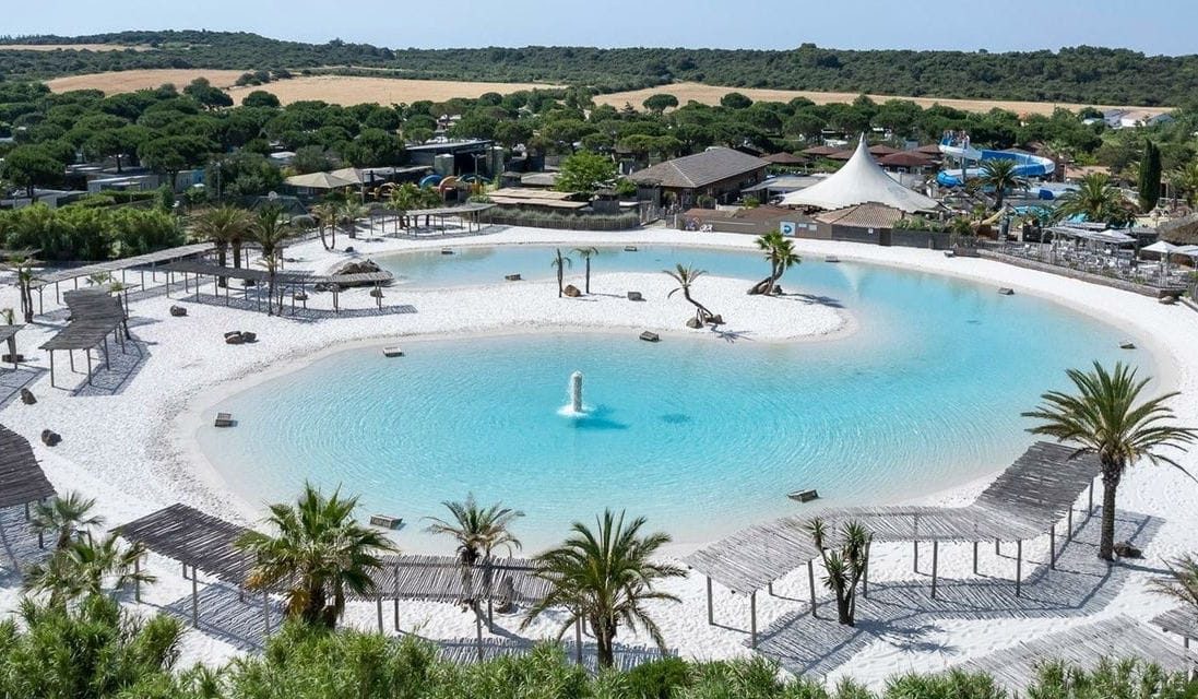 A premium resort lagoon viewed from a lodge deck, upscale seating and turquoise water
