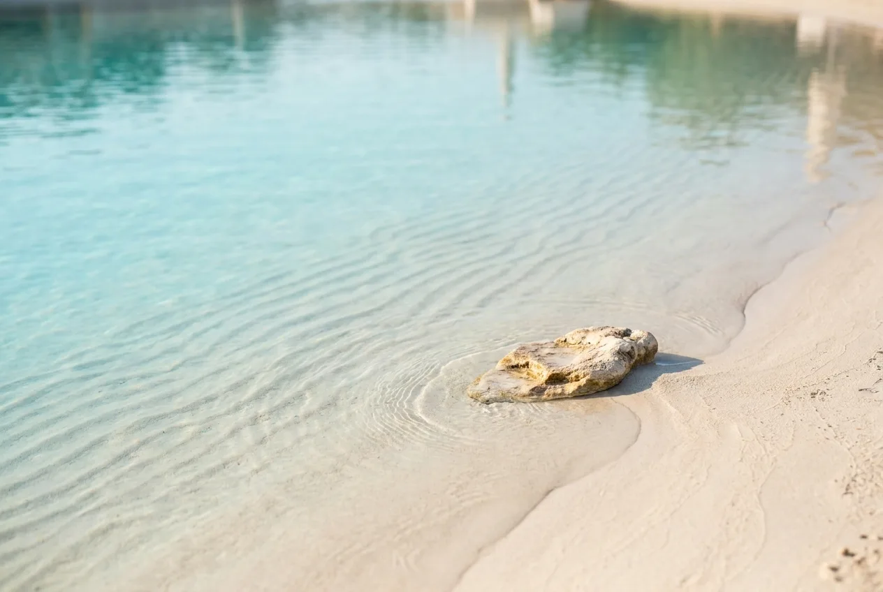A calm, well-kept lagoon detail with clear water, reading as low-upkeep and effortless